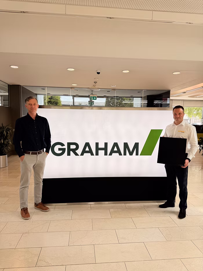 Corporate interior meeting space featuring Graham branding on the wall.