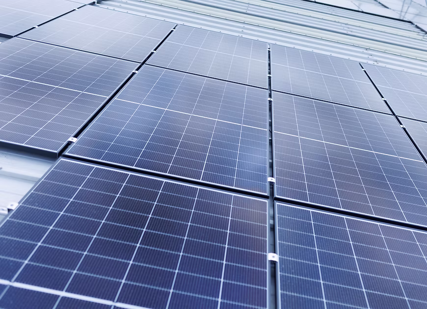 Close-up perspective shot of solar panel glass modules.