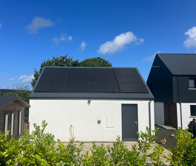 Modern residential home featuring a clean rooftop solar panel setup under a clear sky.