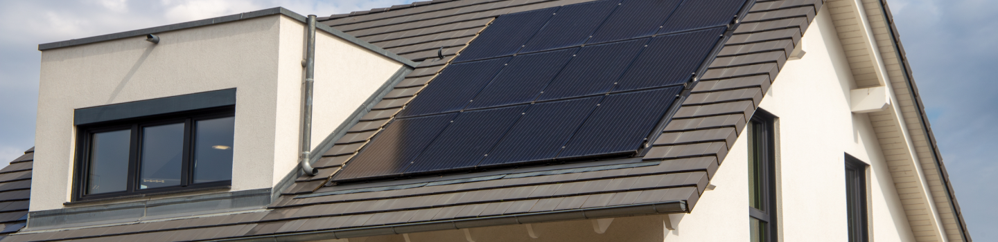 Integrated roof solar panel installation flush-mounted on a slate house roof.