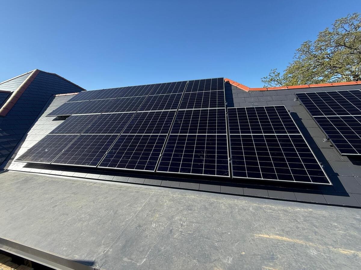 All-black solar panel installation mounted across a residential tiled roof.