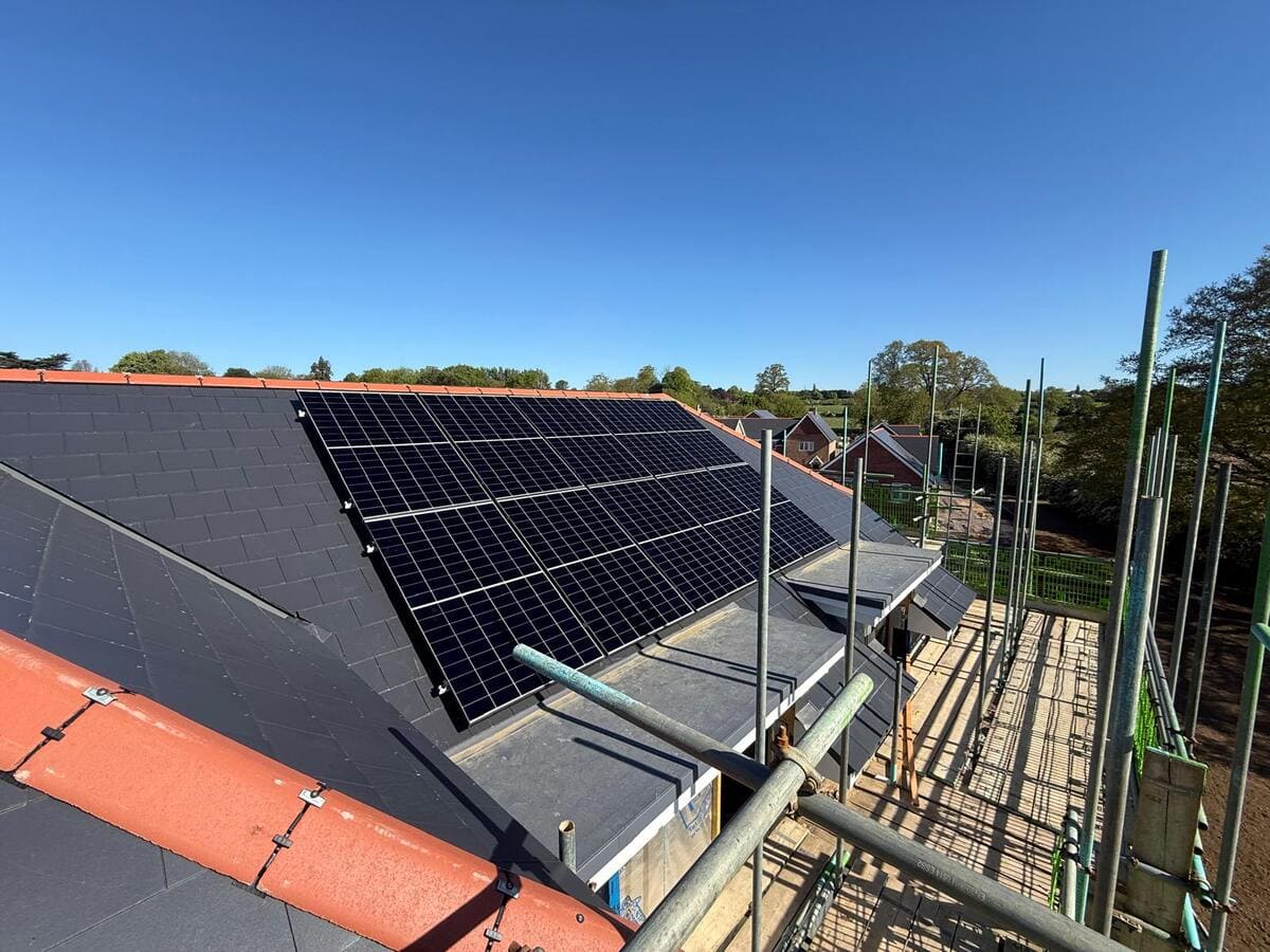 Tilted solar panels mounted on a pitched residential roof surface.