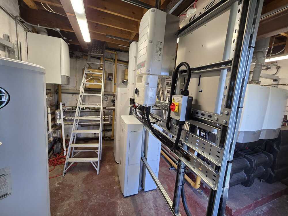 Side view of indoor commercial heating or power equipment installation with a step ladder nearby