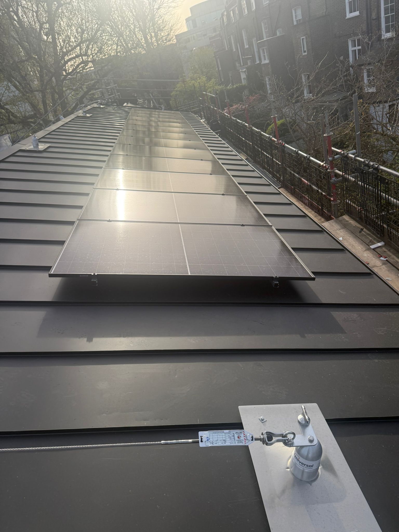 Close-up of solar panel glass reflecting sunlight on a rooftop.