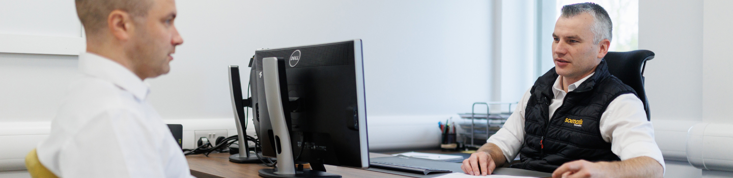 Modern office workstation featuring dual computer monitors on a desk.